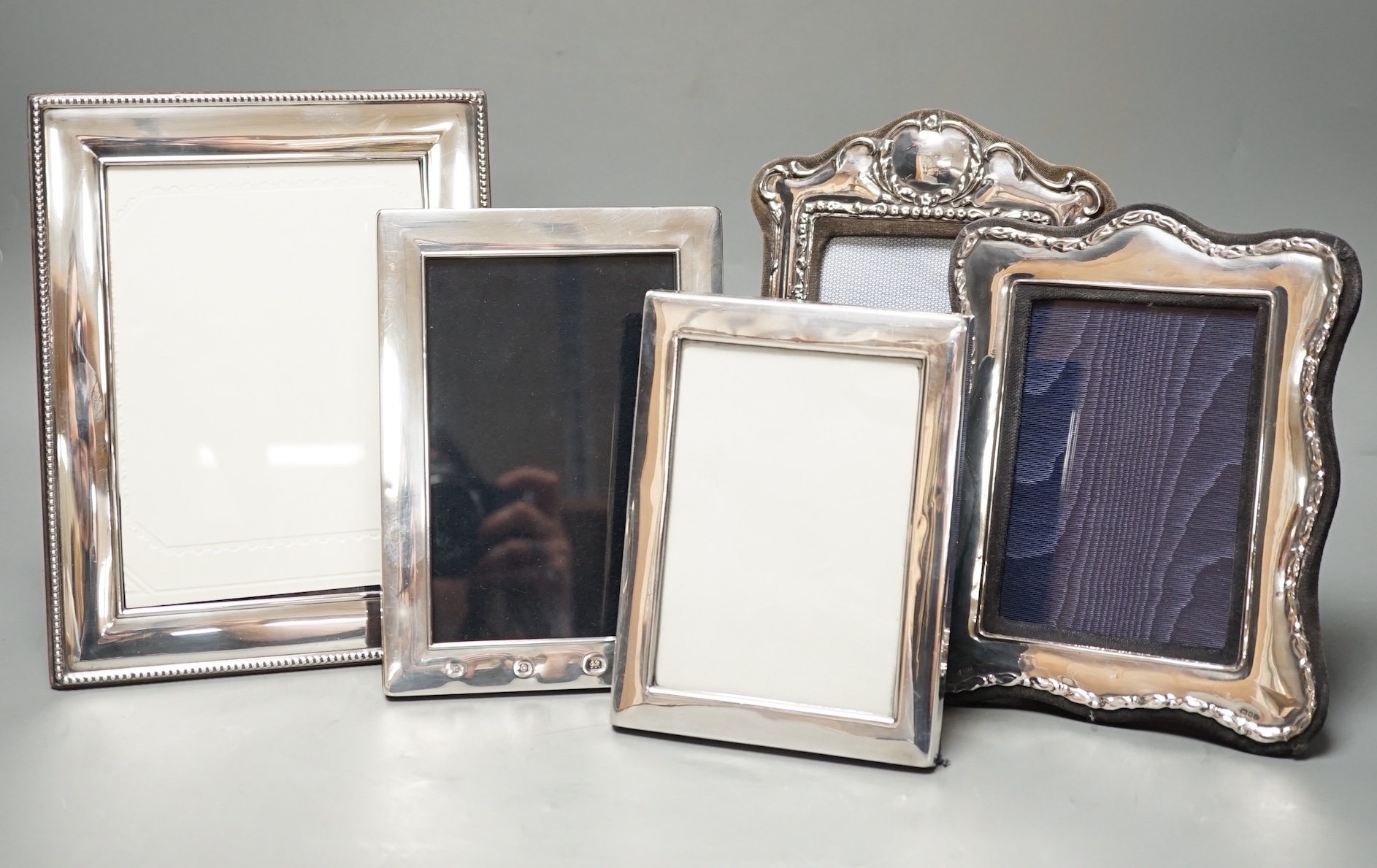 Four assorted modern silver mounted photograph frames, largest 22.2cm and an E.P.N.S. mounted photograph frame.